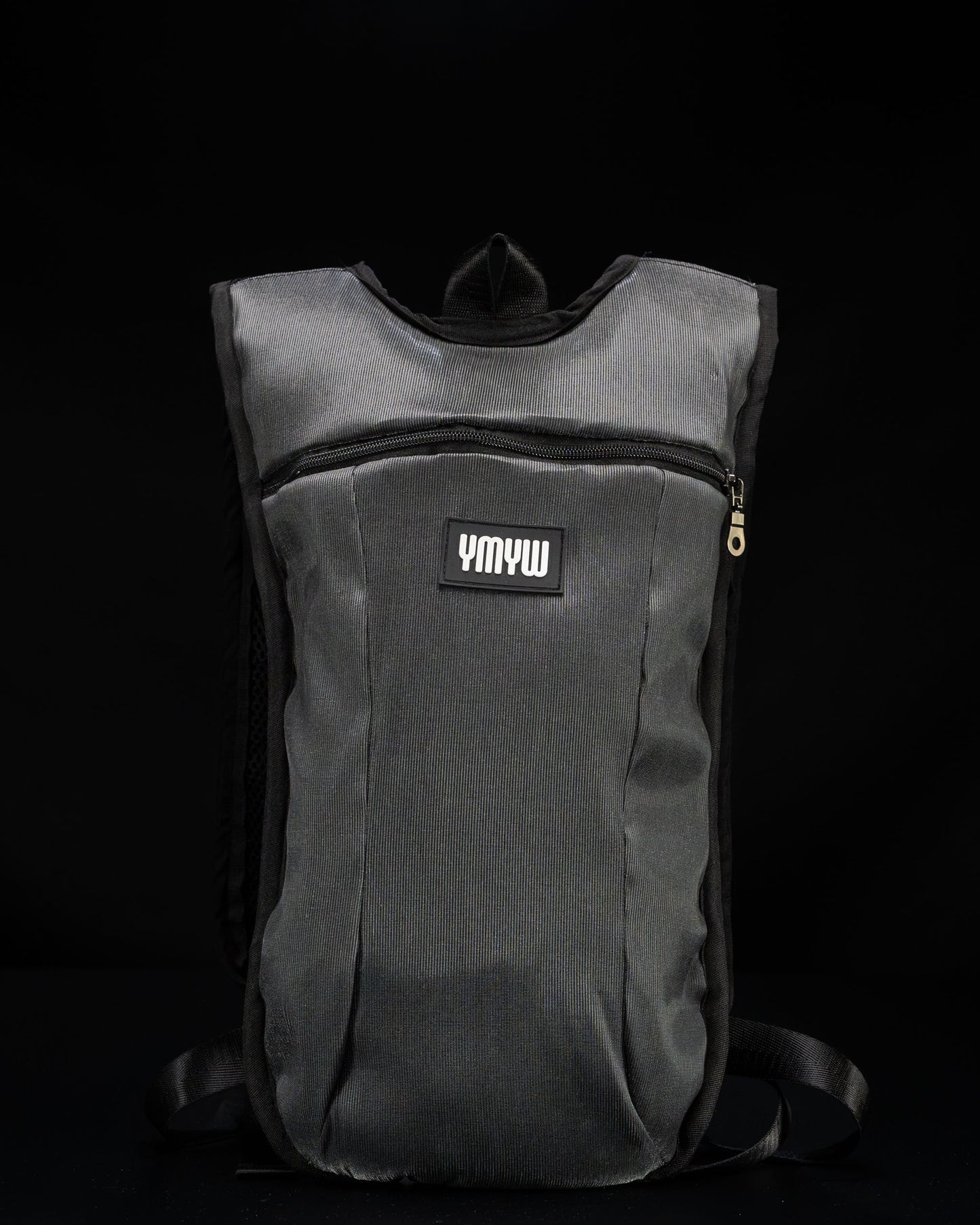 Unlit fiber optic light up hydration backpack showing YMYW logo on a dark background