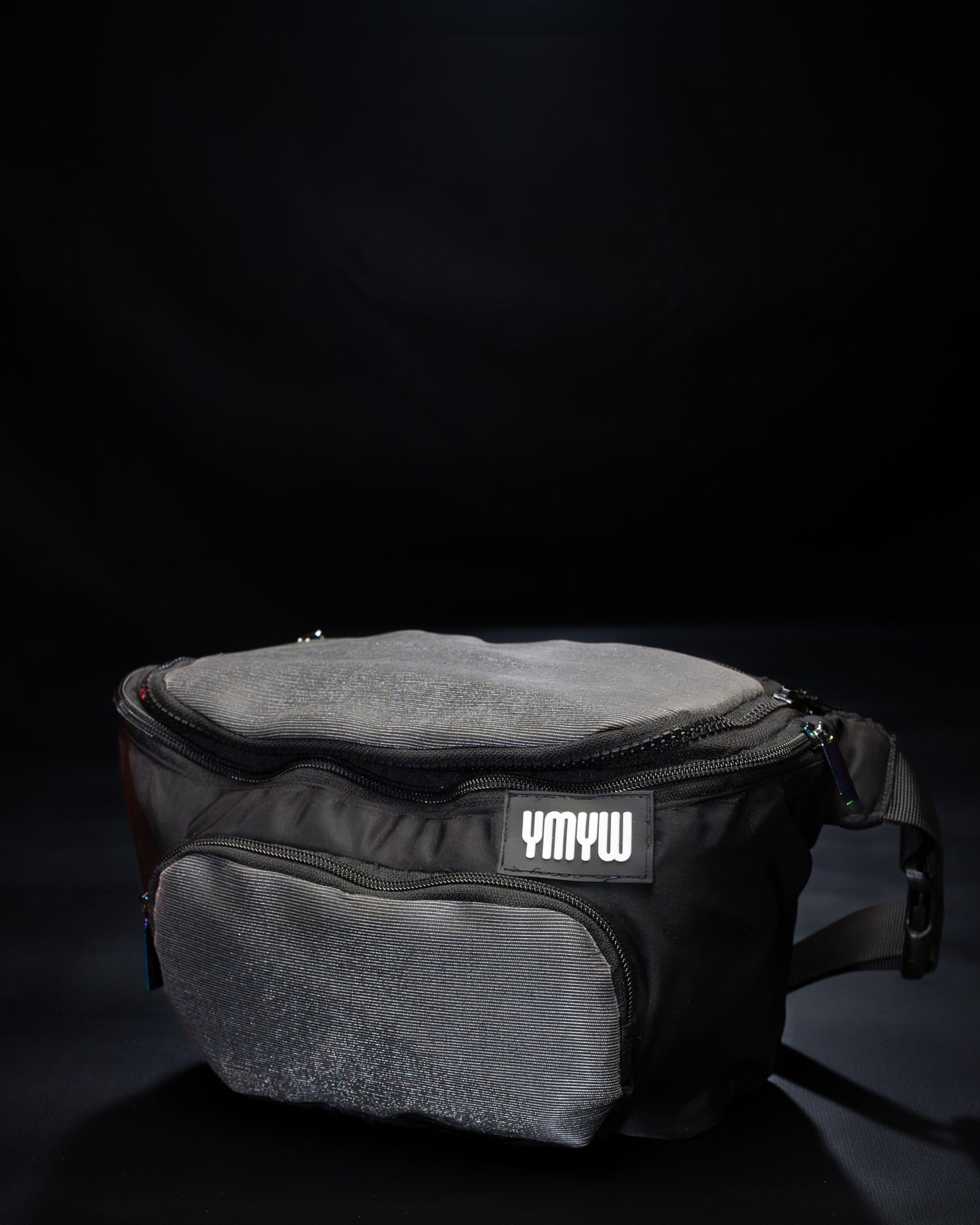 Unlit fiber optic light up waist bag showing "YMYW" logo on a dark background