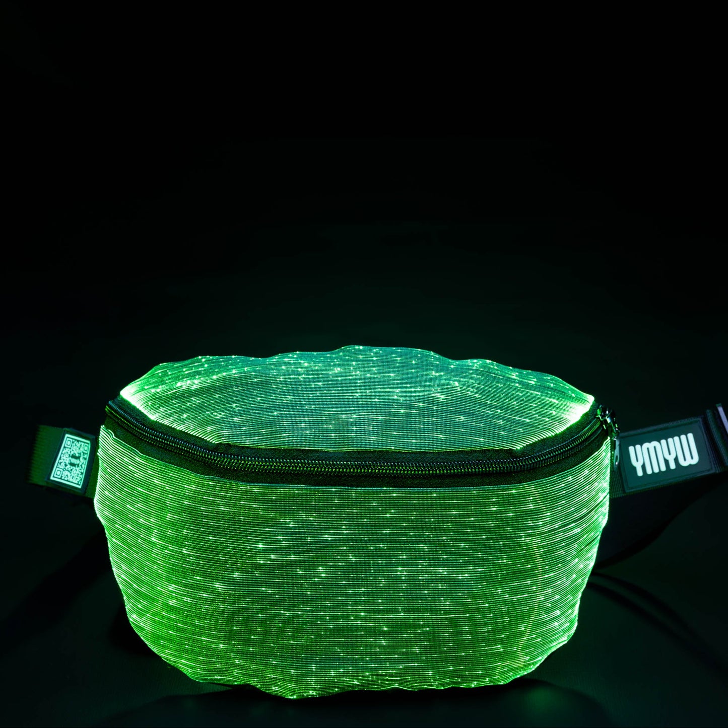 Fiber optic light-up fanny pack illuminated in green light against a dark background