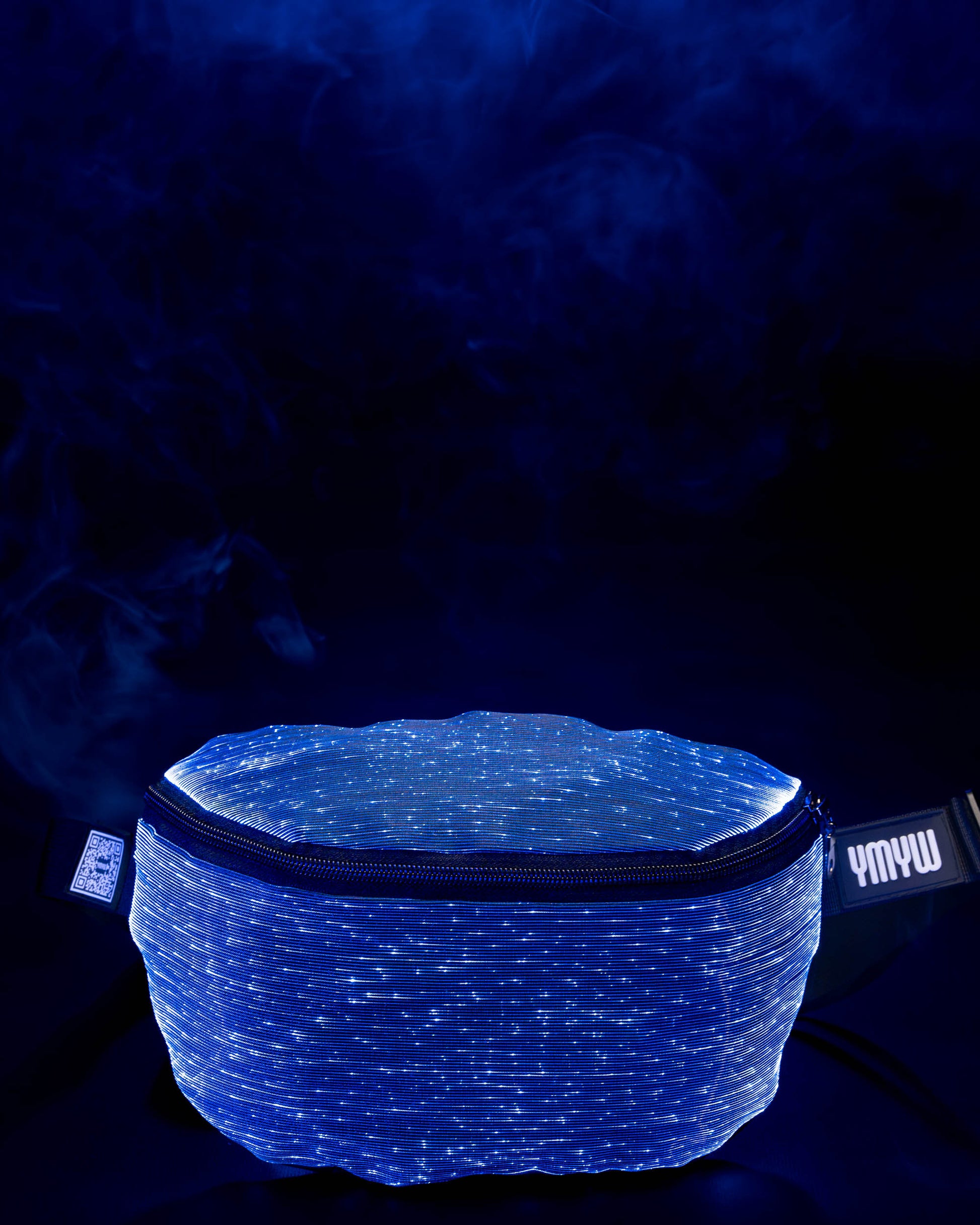 Fiber optic light-up fanny pack illuminated in blue light against a dark background