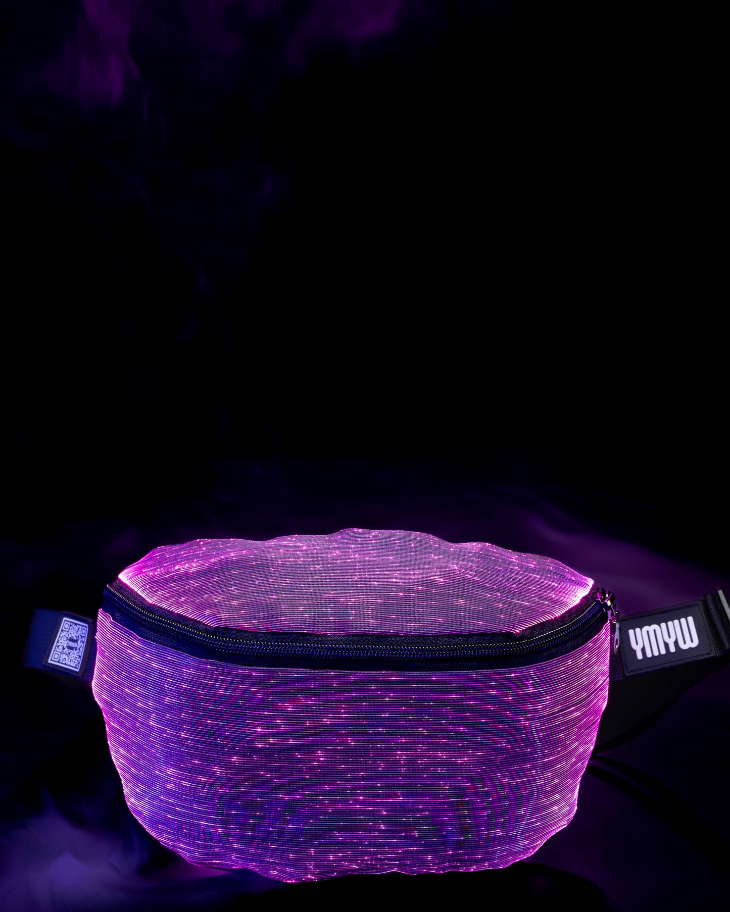 Fiber optic light-up fanny pack illuminated in purple light against a dark background