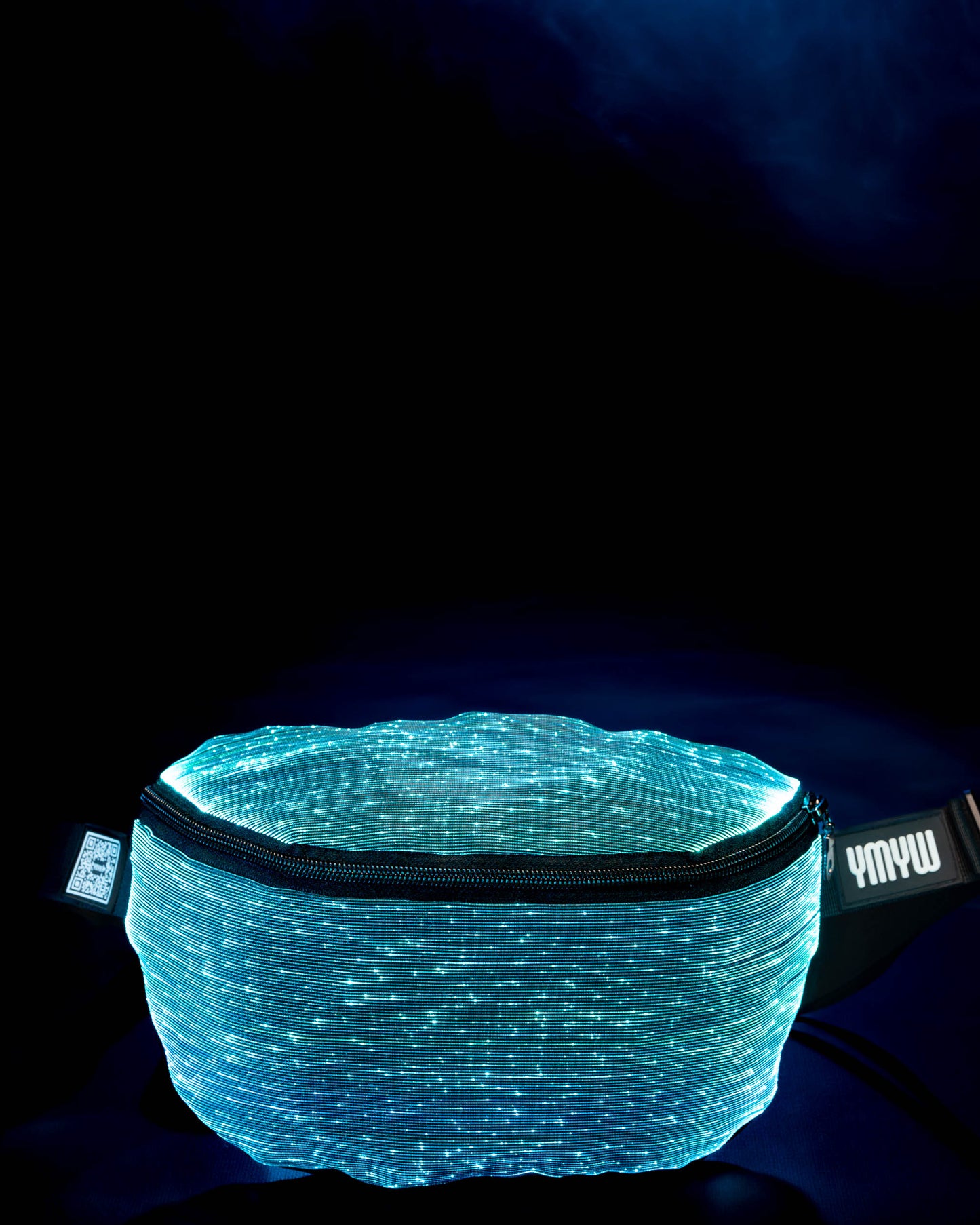 Fiber optic light-up fanny pack illuminated in cyan light against a dark background