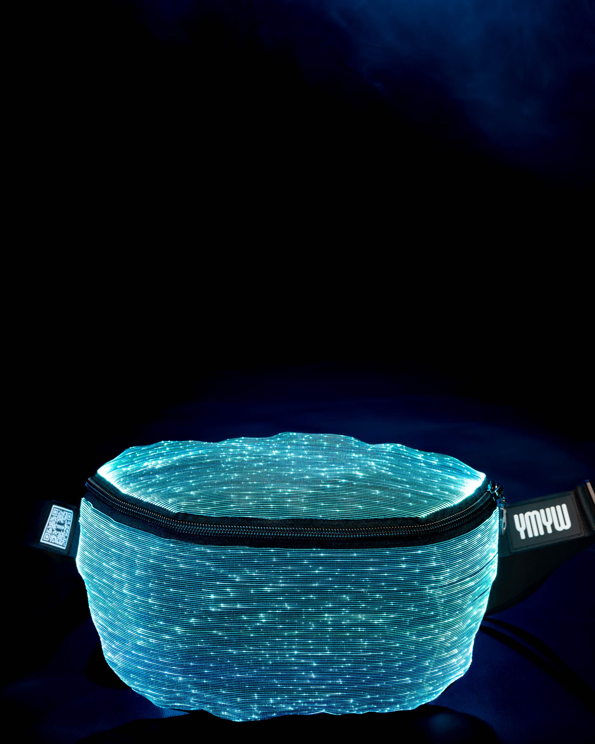 Fiber optic light-up fanny pack illuminated in cyan light against a dark background