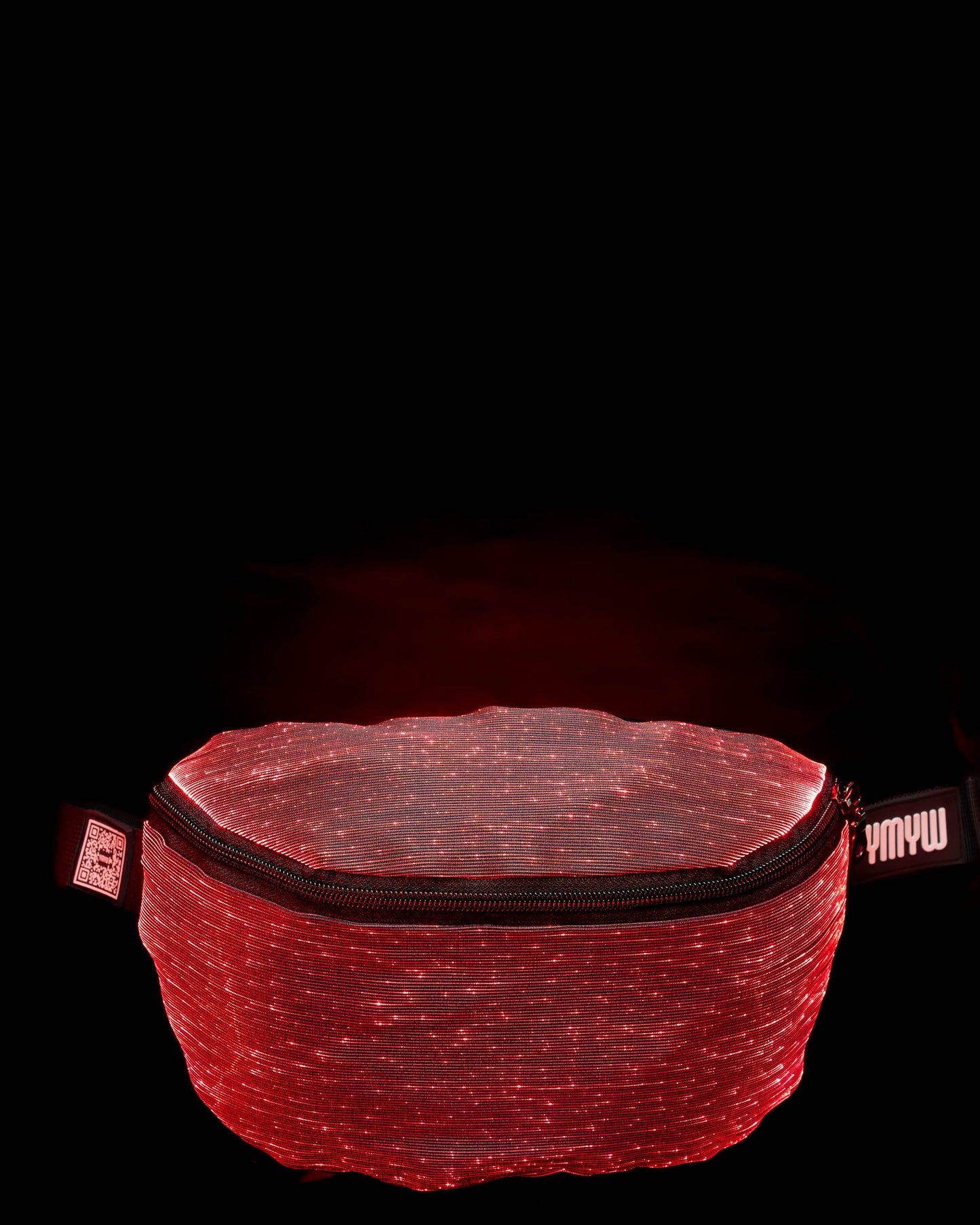 Fiber optic light-up fanny pack illuminated in red light against a dark background