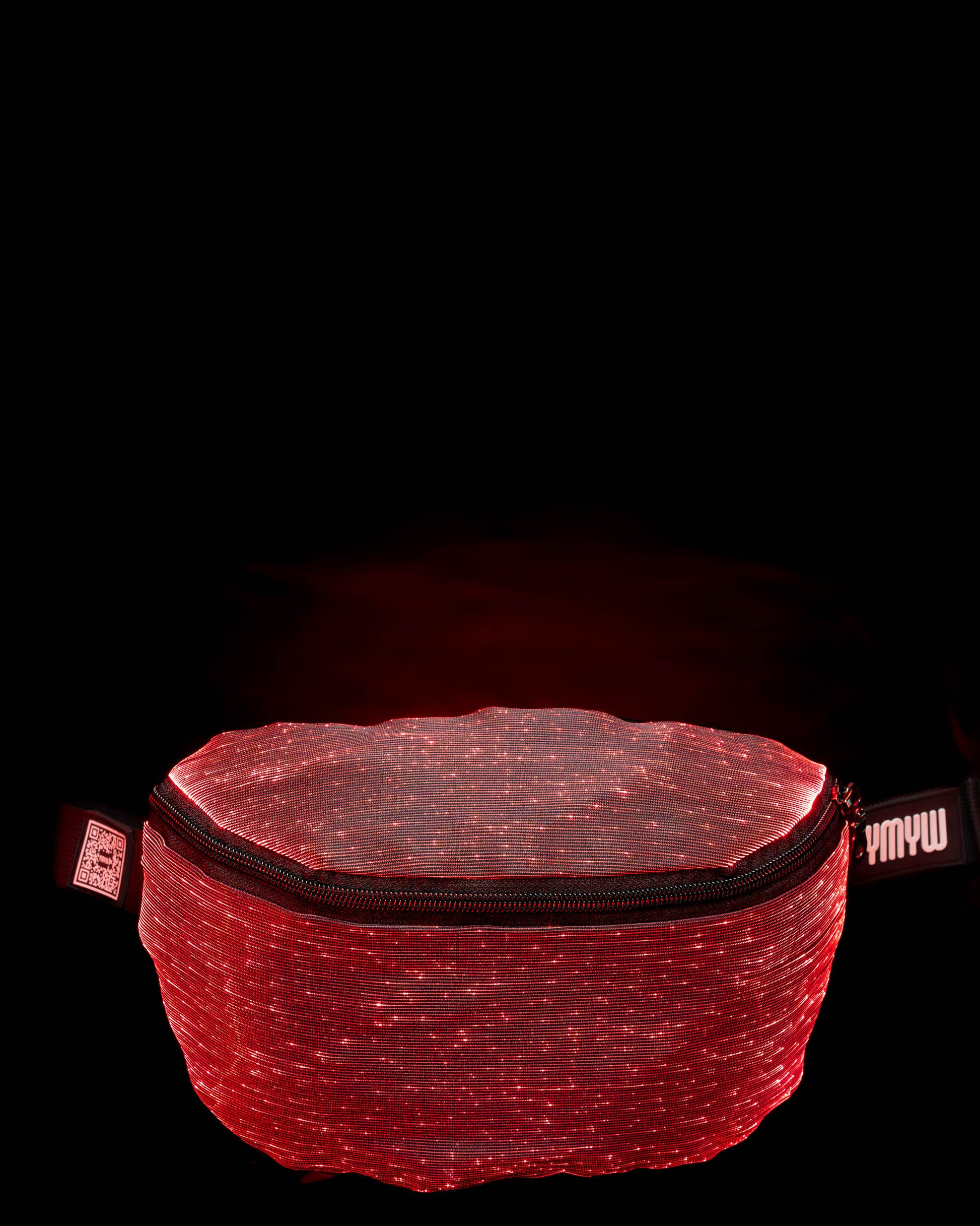 Fiber optic light-up fanny pack illuminated in red light against a dark background