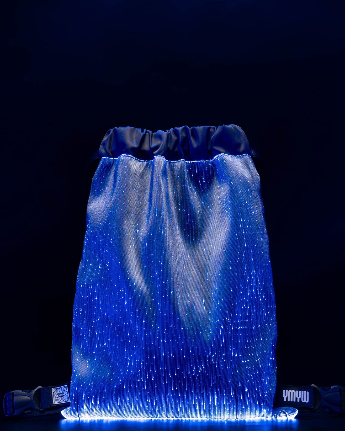 Fiber optic drawstring backpack illuminated in blue light against a dark background