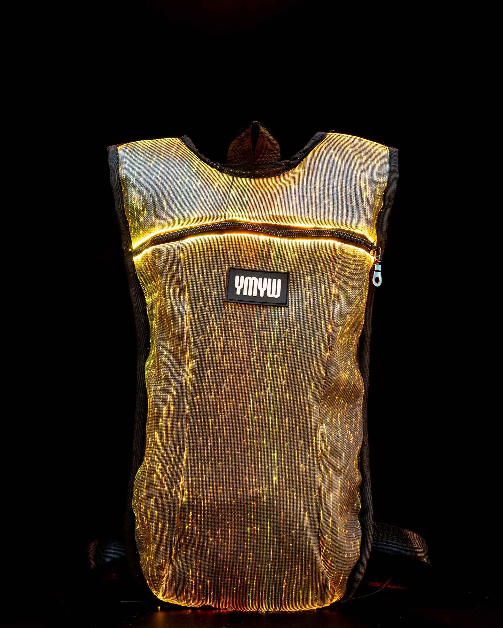Fiber optic light up hydration backpack glowing in golden light with YMYW logo visible on a dark background