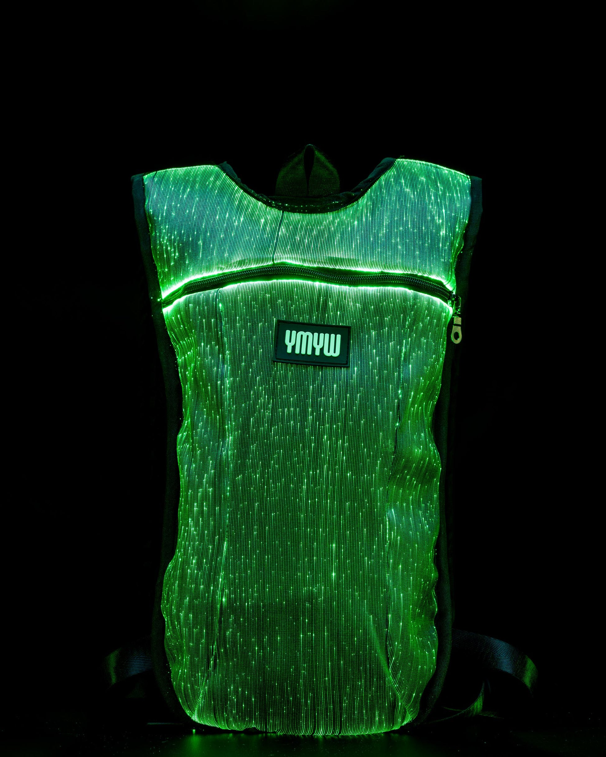 Fiber optic light up hydration backpack glowing in green light with YMYW logo visible on a dark background