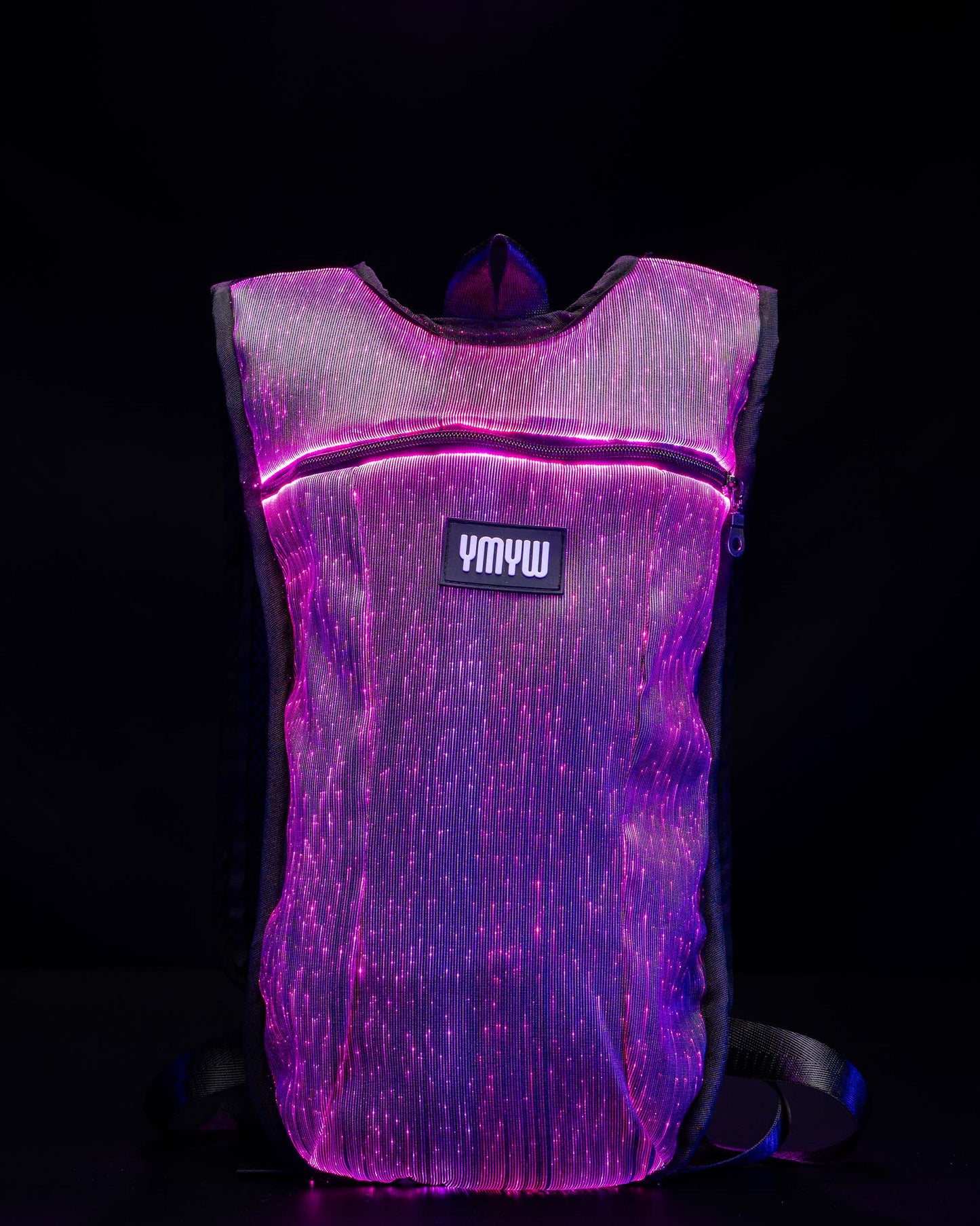 Fiber optic light up hydration backpack glowing in purple light with YMYW logo visible on a dark background
