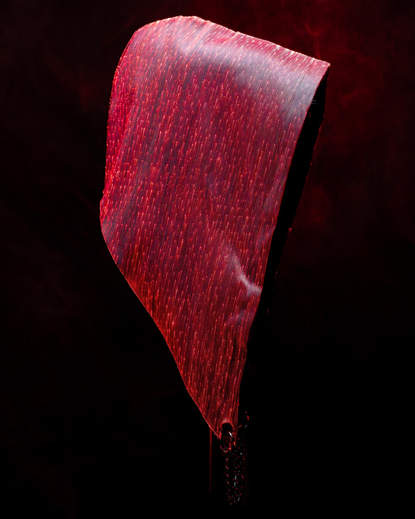 Fiber optic light-up hood illuminated in red light against a dark background