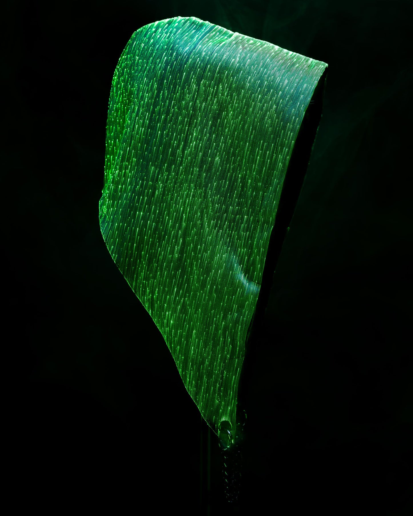 Fiber optic light-up hood illuminated in green light against a dark background