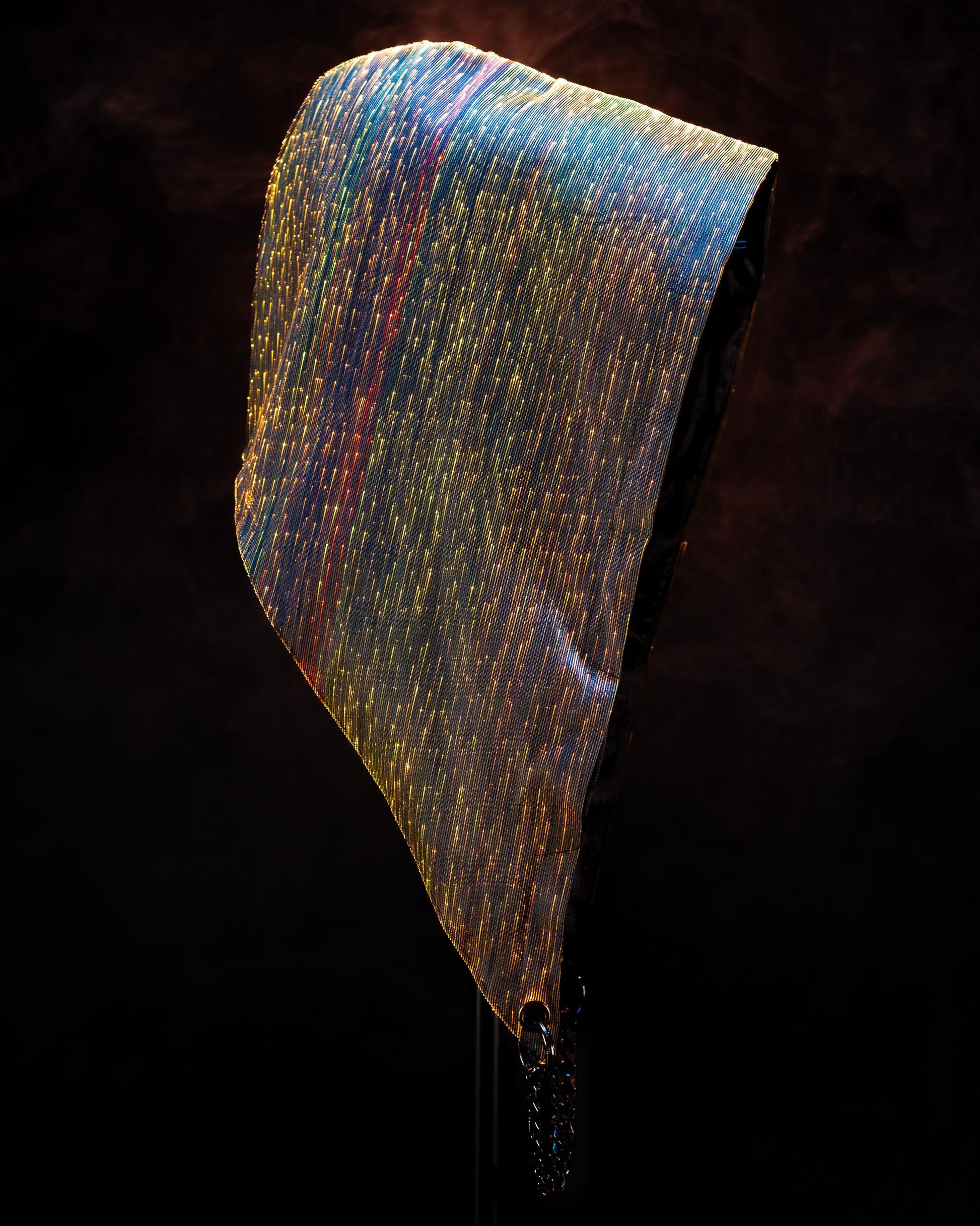 Fiber optic light-up hood illuminated in yellow and orange light against a dark background