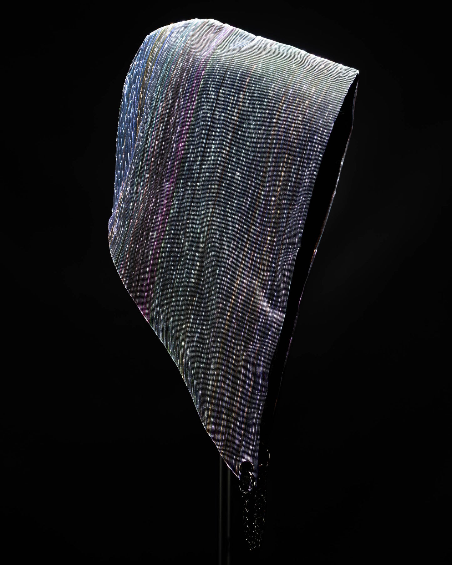 Fiber optic light-up hood illuminated in white light against a dark background
