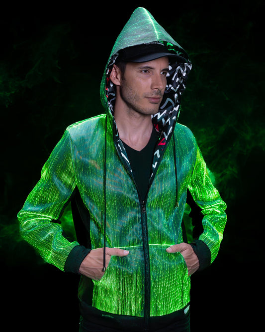 Man wearing a fiber optic LED hoodie illuminated in green with hood up, glowing against a dark background