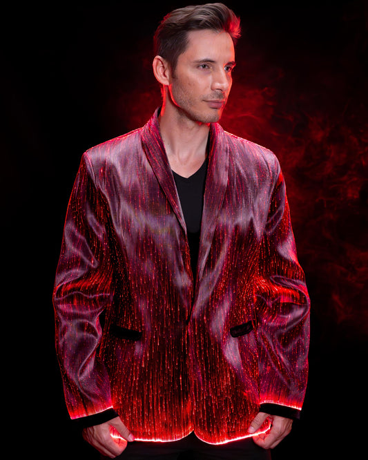 Man wearing a fiber optic light-up suit jacket illuminated in red light against a dark background