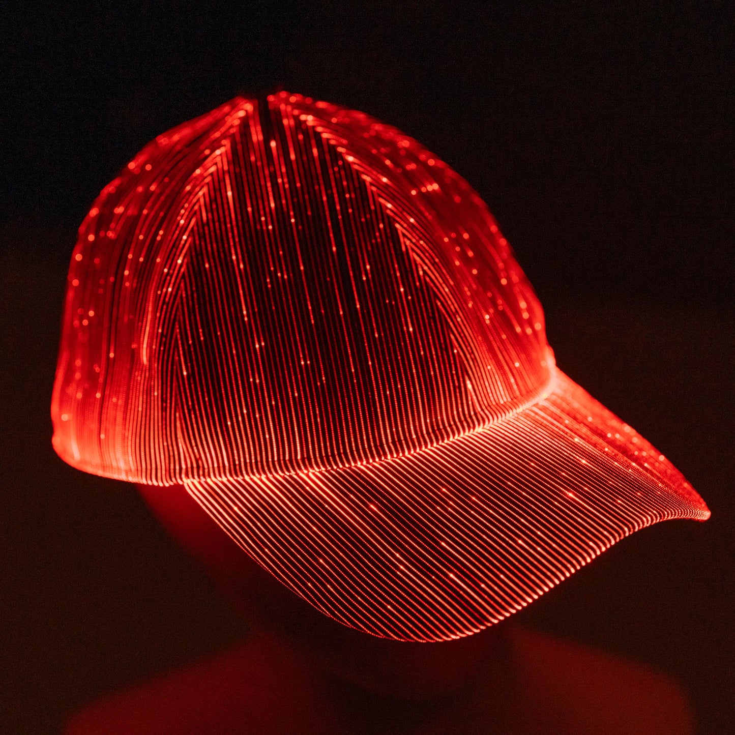 fiber optic LED snapback glowing in bright red light on a dark background