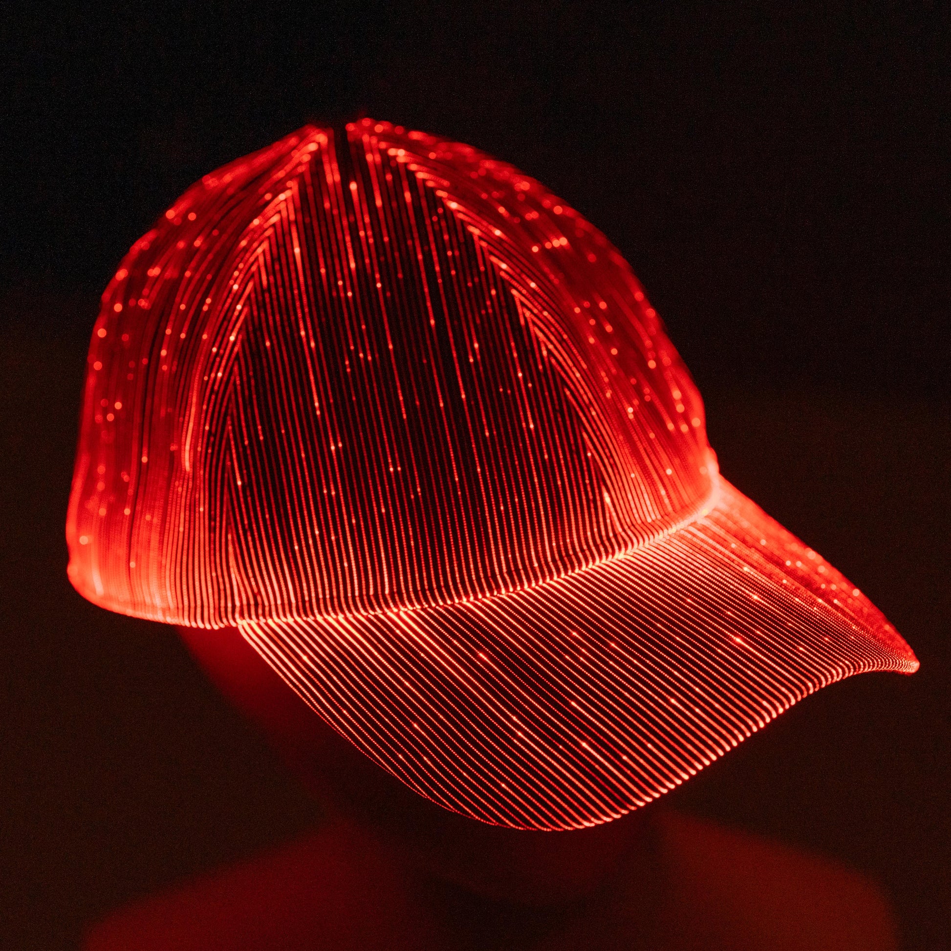 fiber optic LED snapback glowing in bright red light on a dark background