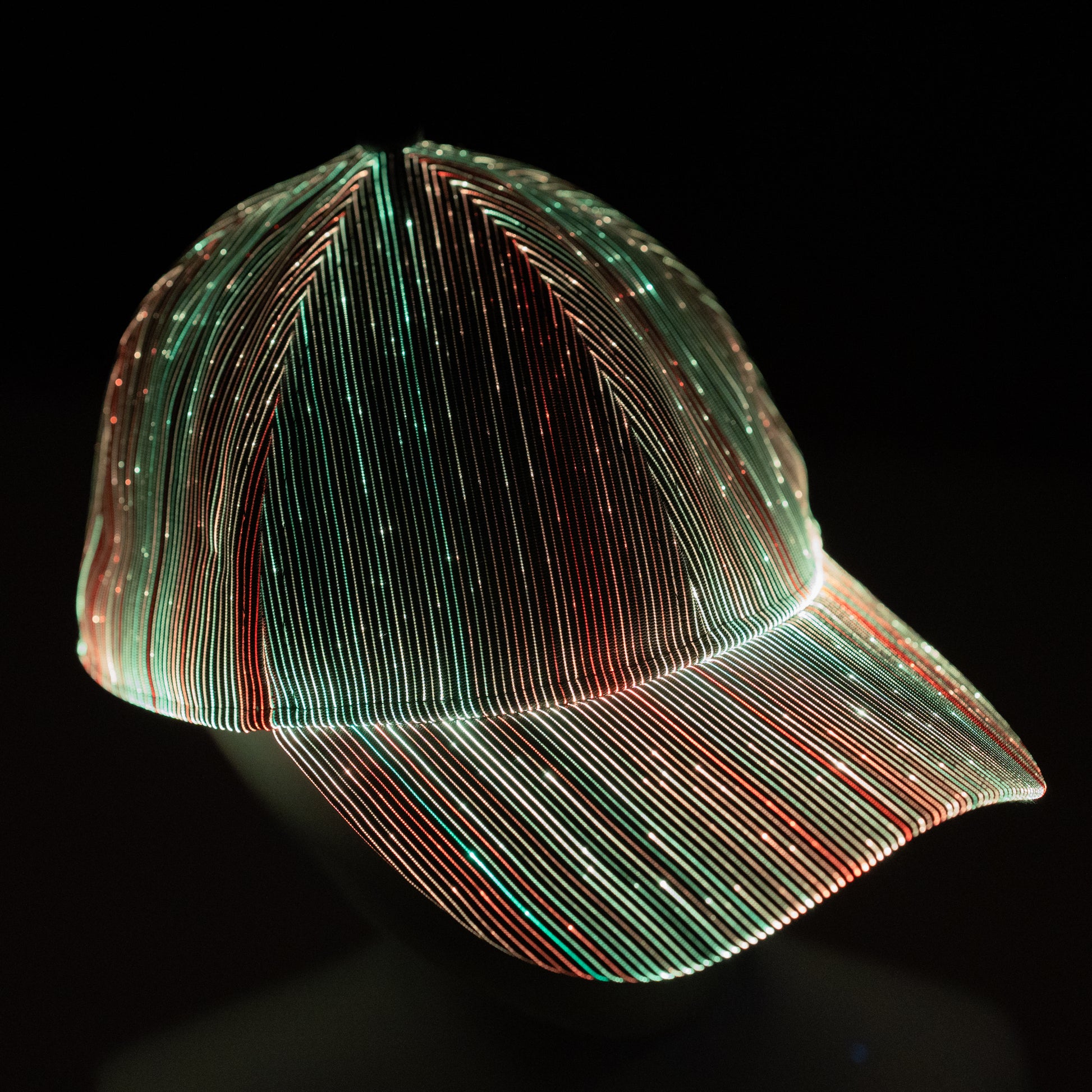 fiber optic LED snapback glowing in bright multicolor light on a dark background