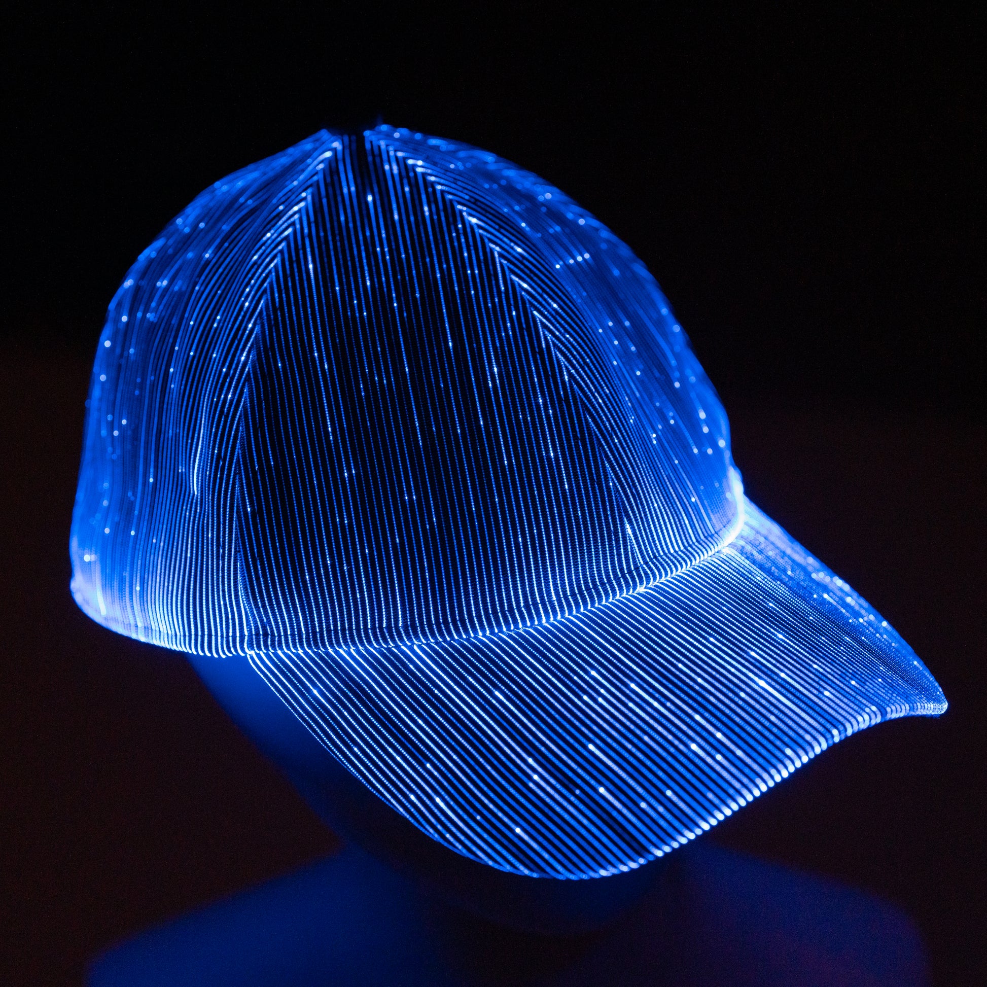 fiber optic LED snapback glowing in bright blue light on a dark background