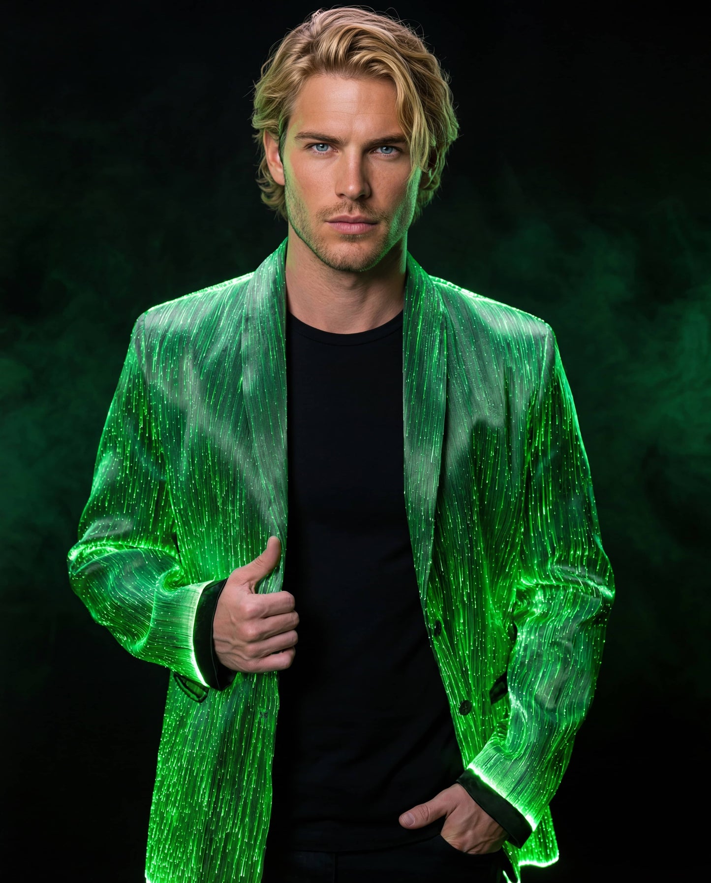 Man wearing a glowing green fiber-optic suit jacket, standing against a dark green smoke-filled background