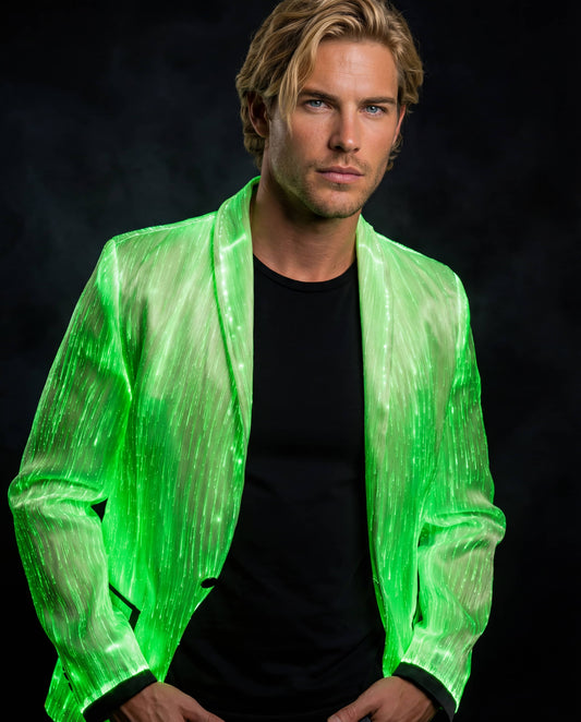 Man wearing a glowing green fiber-optic suit jacket, standing against a dark smoky background with his hands in his pockets