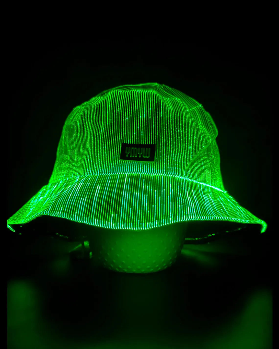 Fiber optic light up bucket hat glowing in vivid green LED colors on a dark background