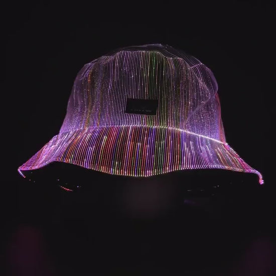 Fiber optic light up bucket hat cycling through vivid multi-color LED modes on a dark background