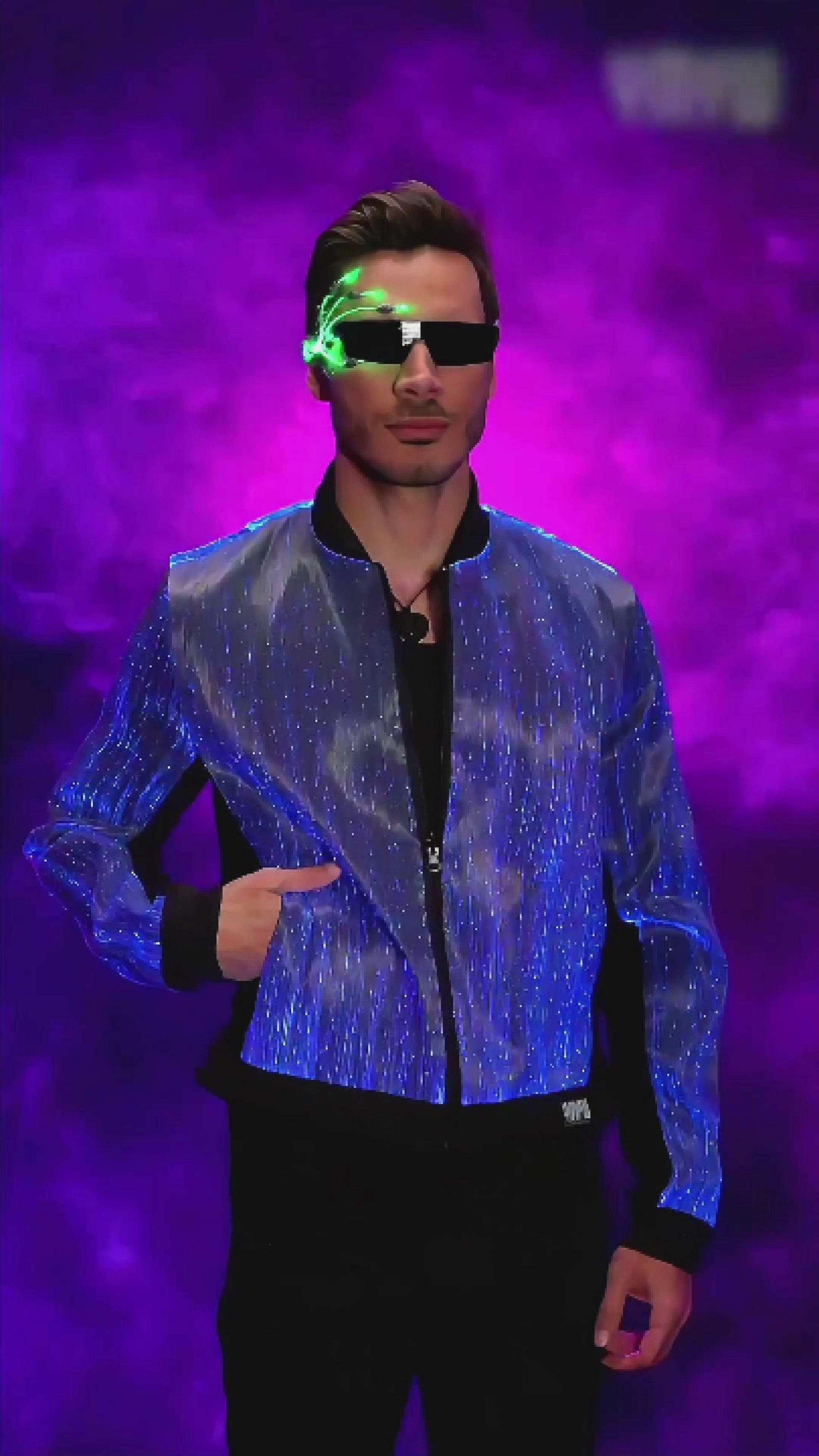 Man wearing a fiber optic LED bomber jacket rotating on a platform, the jacket glowing in shifting colors against a dark studio background