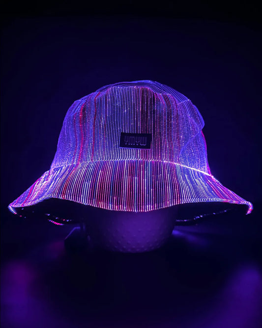 Fiber optic light up bucket hat glowing in vivid purple LED colors on a dark background