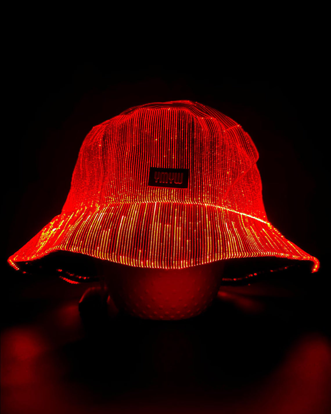 Fiber optic light up bucket hat glowing in vivid red LED colors on a dark background