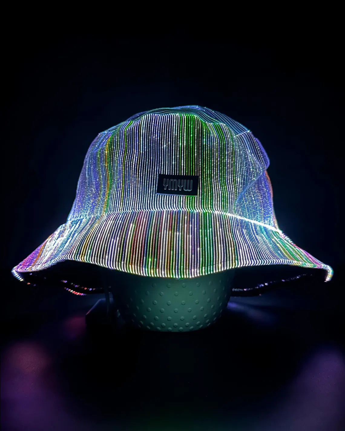 Fiber optic light up bucket hat glowing in vivid multicolor LED colors on a dark background